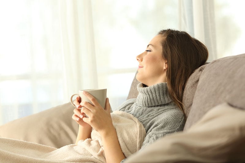 Happy Woman Relaxing on Couch